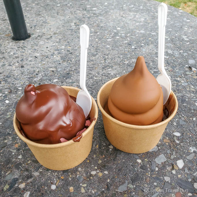 Two ice creams dipped in chocolate with spoons sticking out from Chocolaterie de l'Ile d'Orleans