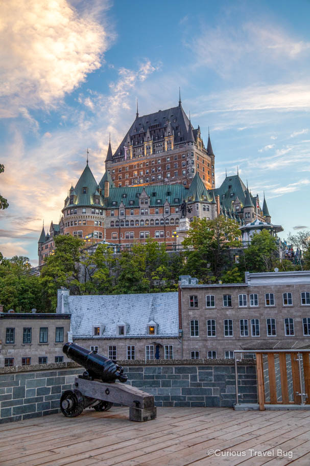 Chateau Frontenac at sunset with a cannon in front of it in Quebec City, Canada