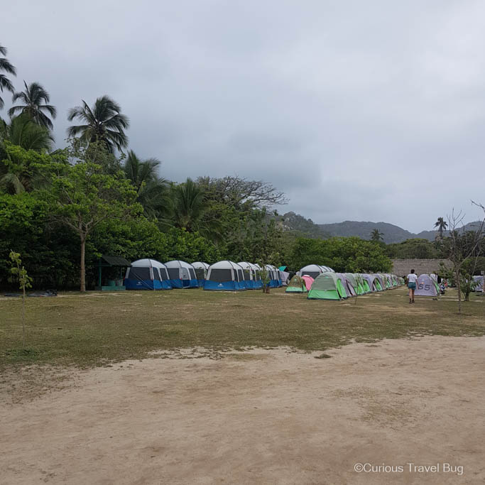 Rows of blue and green tents that you can rent at Cabo San Juan in Parque Tayrona