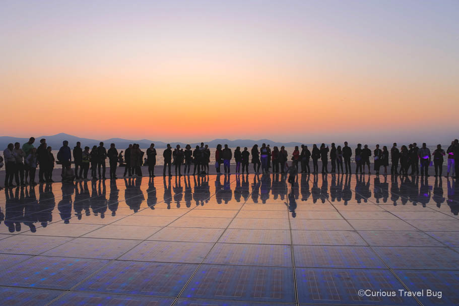 Sunset in Zadar, Croatia at the monument to the sun. This is the perfect place to end your two weeks in Croatia and Slovenia.