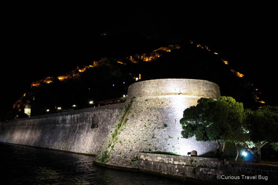 The walls of Kotor Montenegro lit up at night on the mountainside