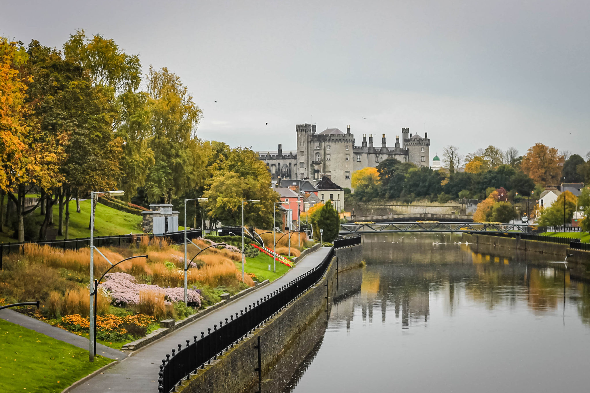 Kilkenny Ireland with the Nore River and Kilkenny Castle in the background during an autumn rain. Kilkenny is famous for the Medieval Mile and having a historic medieval city.