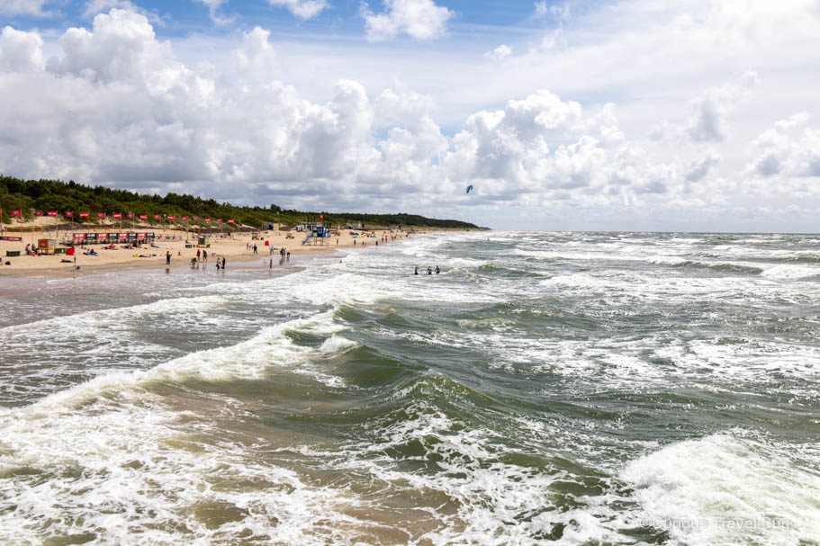 View of the beach at Palanga with the waves of the Baltic Sea and the golden sandy beach. Palanga is a top destination in Lithuania and is one of the best places to visit on the Baltic Sea.