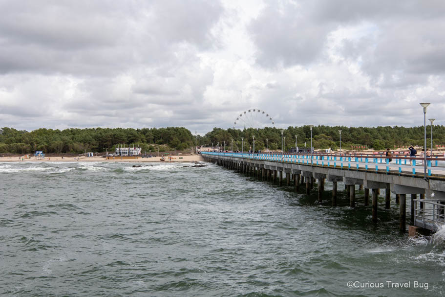 Palanga Bridge with ferris wheel in the background on a cloudy day