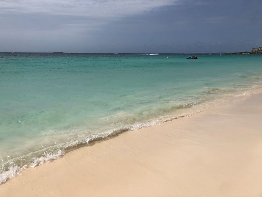 The white and of Eagle Beach in Aruba as storm clouds roll in. Aruba is one of the ABC islands and is well worth a visit to explore this Caribbean destination.