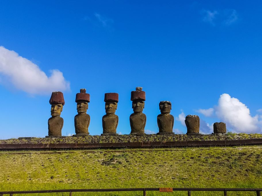 The most famous Easter Island head statues, also known as moai, stand in front of a blue sky on Rapa-Nui, Chile. This remote island is part of Polynesia but most easily reached from South America.