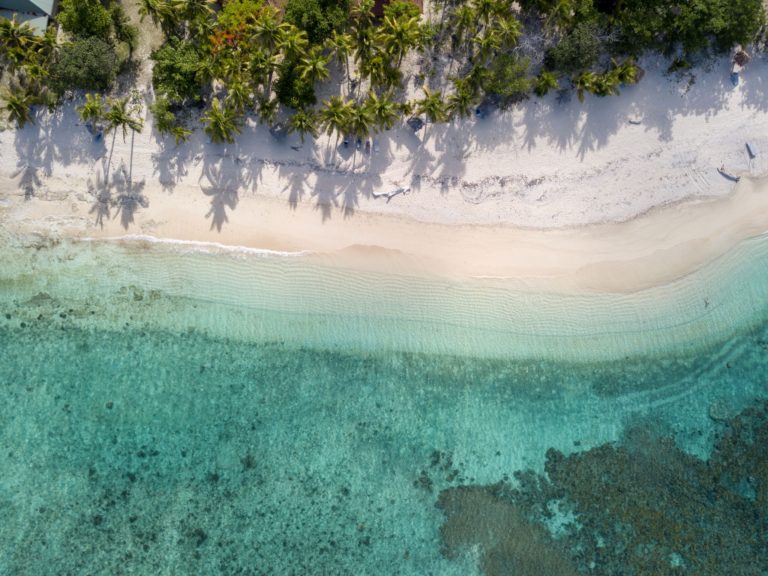 Overhead shot of white side and crystal clear water. The best islands in South America to visit.