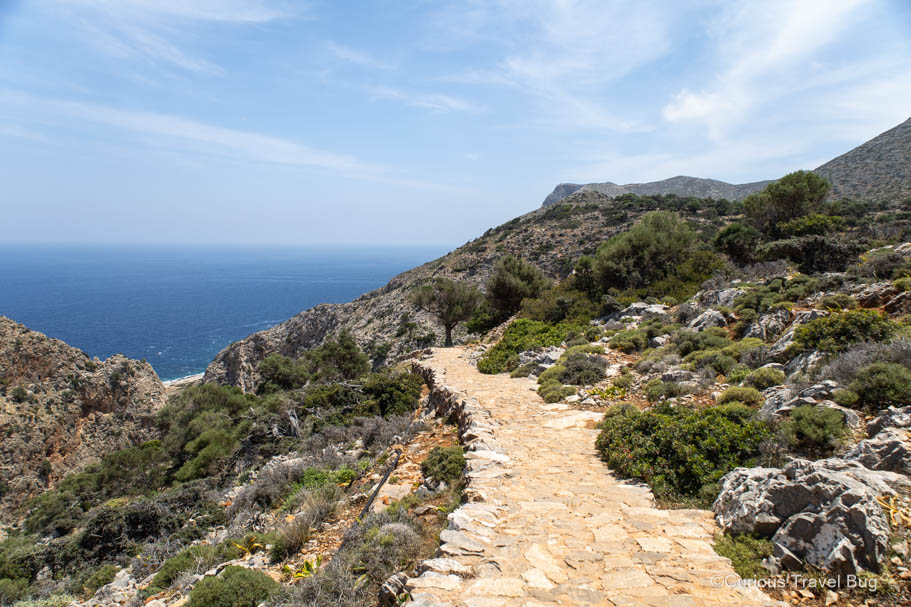 Hiking a mountain path with views of the Aegean Sea at Katholiko Bay, Crete