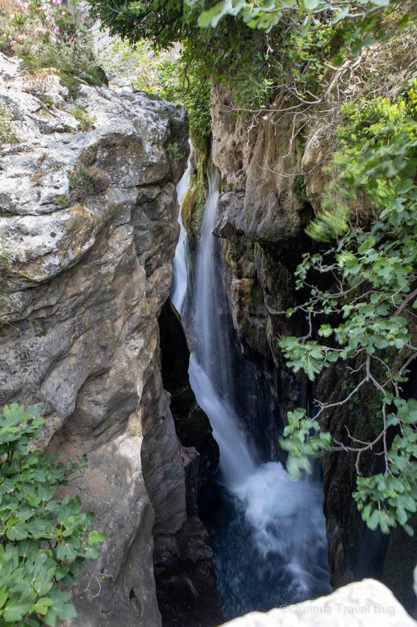 View of waterfalls that are between a narrow gorge in Kourtaliotiko Gorge, Crete. This is a great stop on Crete road trip on the way to Preveli Beach