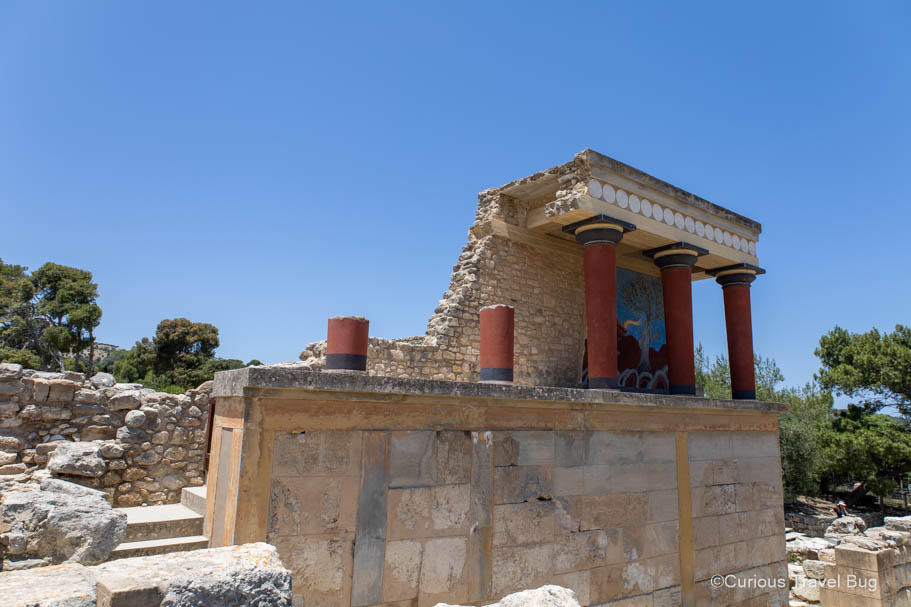 Ruins at Knossos Palace near Heraklion, Crete with three intact red columns.