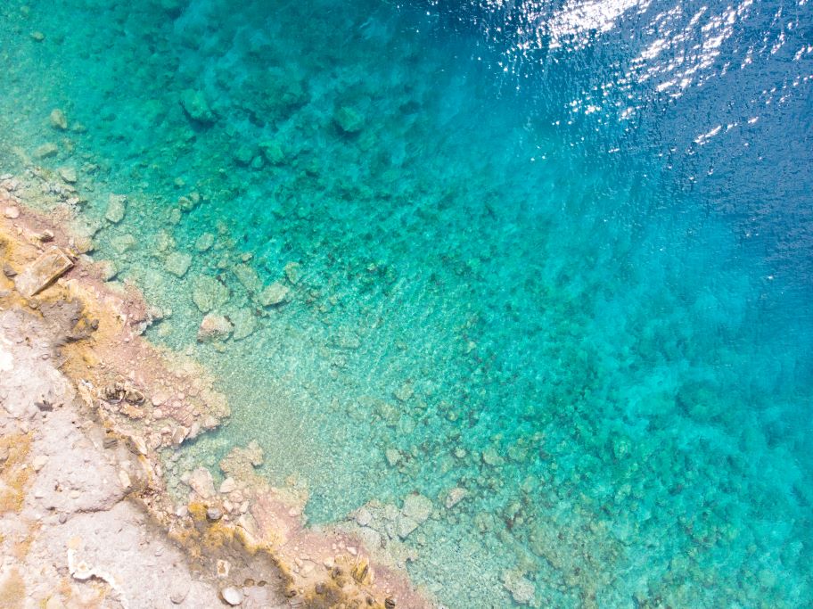 Teal and turquoise water near Aegina Island in Greece. A day trip sailing from Athens is the perfect way to experience Greece.