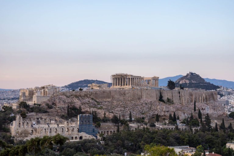 View of the Acropolis from Philopappos Hill at sunset. This itinerary has everything you need for the perfect four days in Athens.