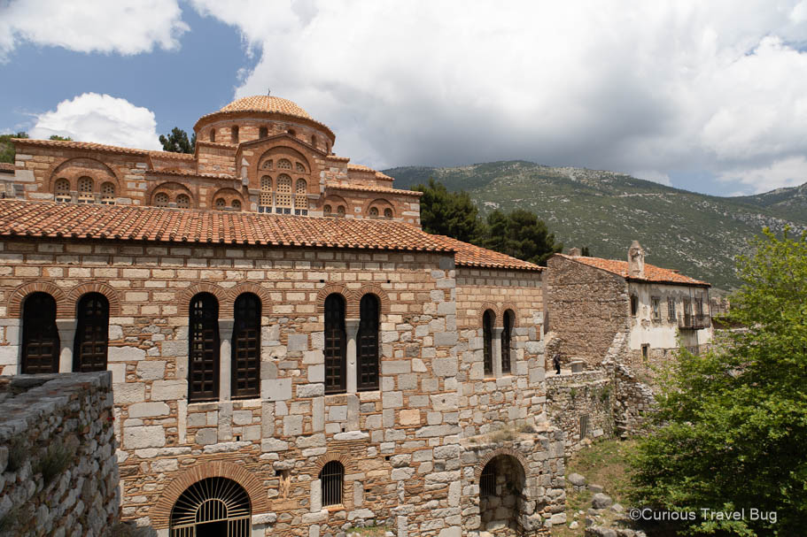 Hosios Loukas Monastery with mountains in the background. This UNESCO Heritage Site is an excellent stop on the way to Delphi when visiting Athens for four days.