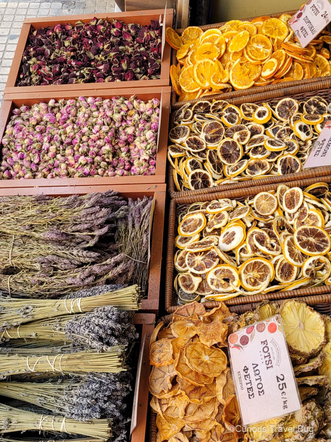 Dried red and pink roses, oranges, blood oranges, lemons, grapefruits, pineapple, and two types of dried lavender in the spice markets of Athens, Greece.