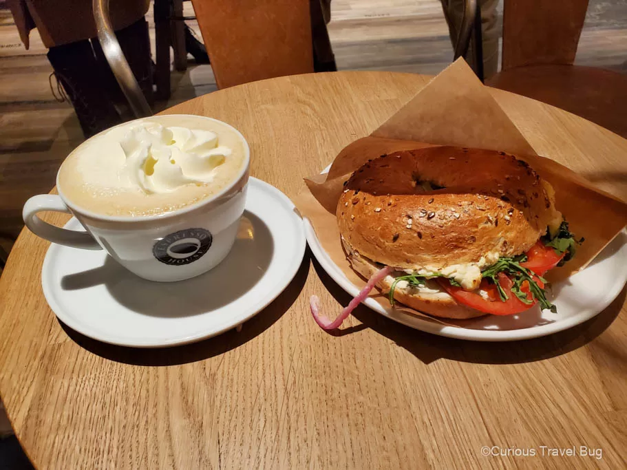 Enjoying a latte and bagel in one of Stockholm's cafe. Enjoying a Fika is the perfect thing to do on a layover in Stockholm.