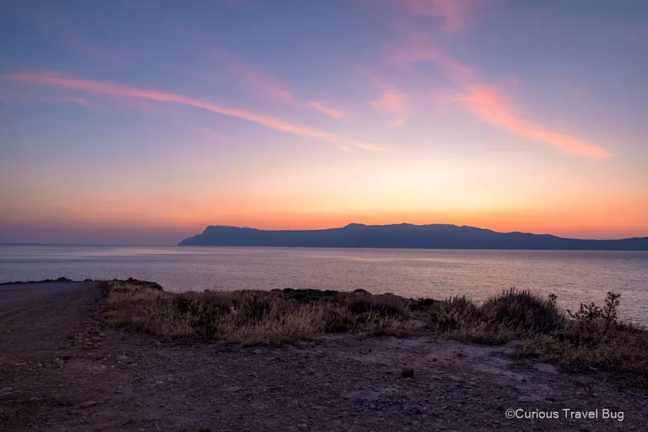 Sunrise over Kissamos Bay in Crete with beautiful shades of coral, pink, purple, and blue