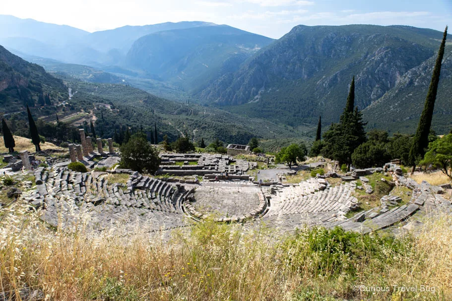View of the Ancient Theatre with the Temple of Apollo in the background at Delphi