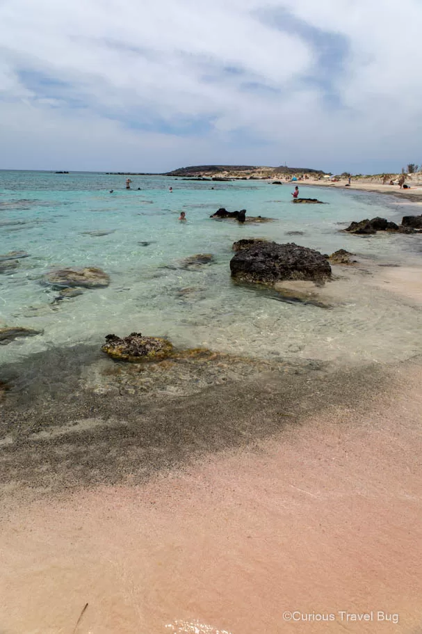 Pink sand mixes with black sand at Elafonisi Island in Crete.