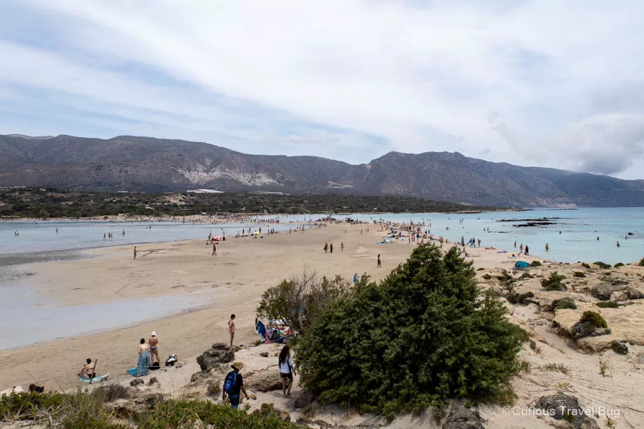 View of the lagoon at Elafonisi Beach with white sand and mountains in the background