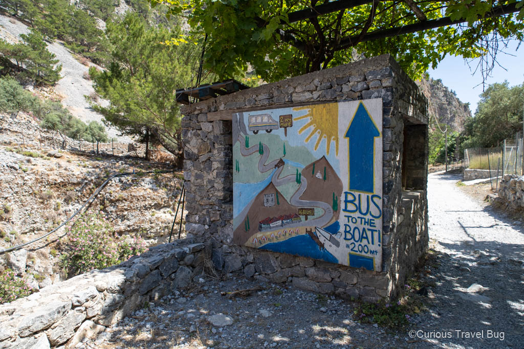 Sign showing that there is a bus to take you to the ferry in Samaria Gorge
