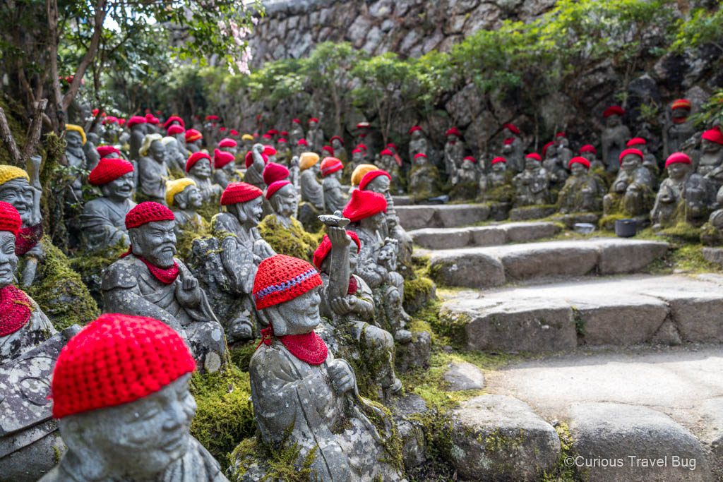 Many Jizo statues with red knit hats at Daishoin Temple in Miyajima