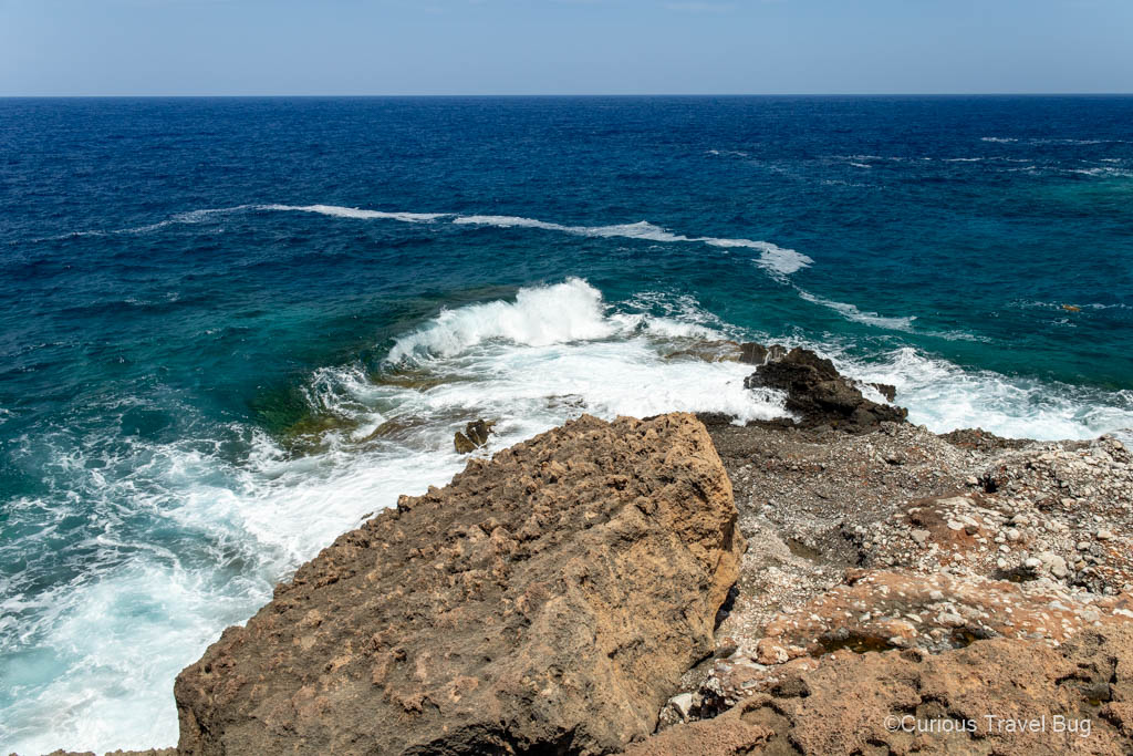 The Sea of Crete and waves that hit the rocky shore of Katholiko Bay